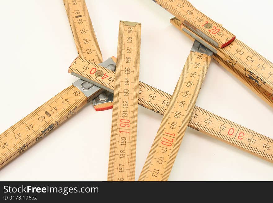 Wooden folding ruler, meter rests on a white