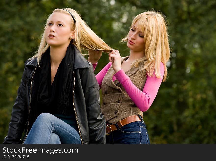 Two sisters in a park having fun. Two sisters in a park having fun