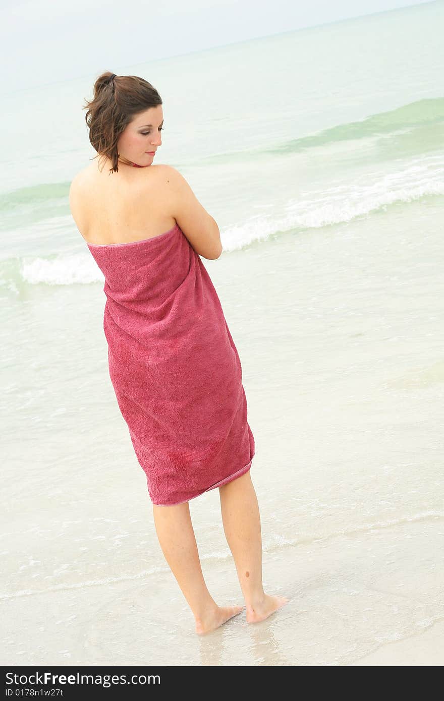 Brunette covering herself with a towel vertical