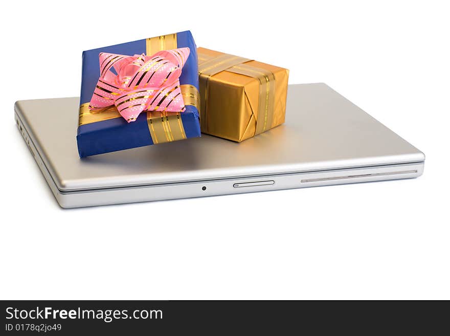 A photo of some gift boxes over laptop. A photo of some gift boxes over laptop