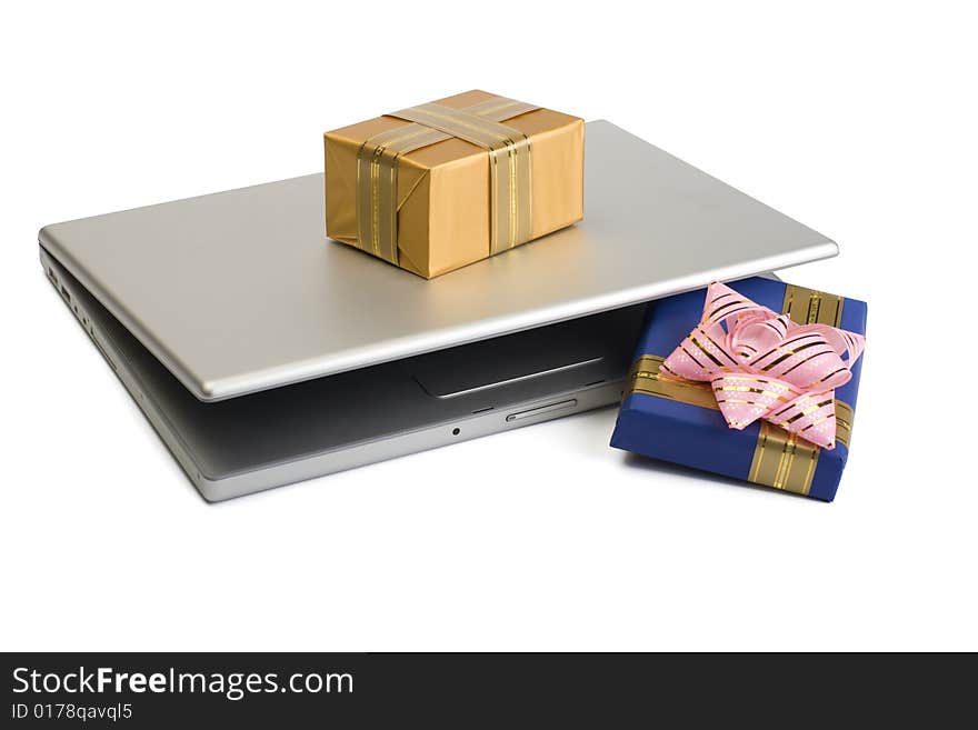 A photo of some gift boxes over laptop. A photo of some gift boxes over laptop