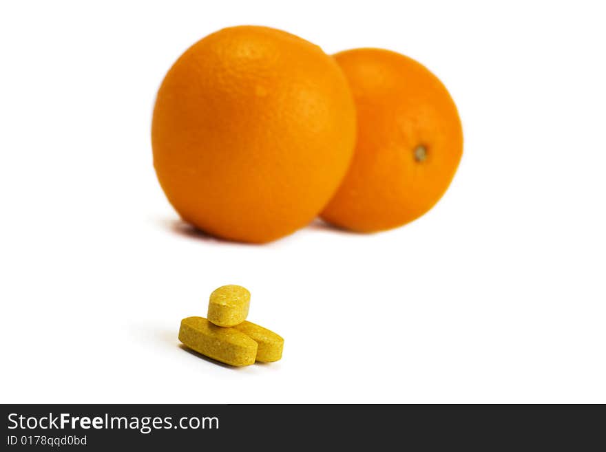 A photo of orange and pills. A photo of orange and pills