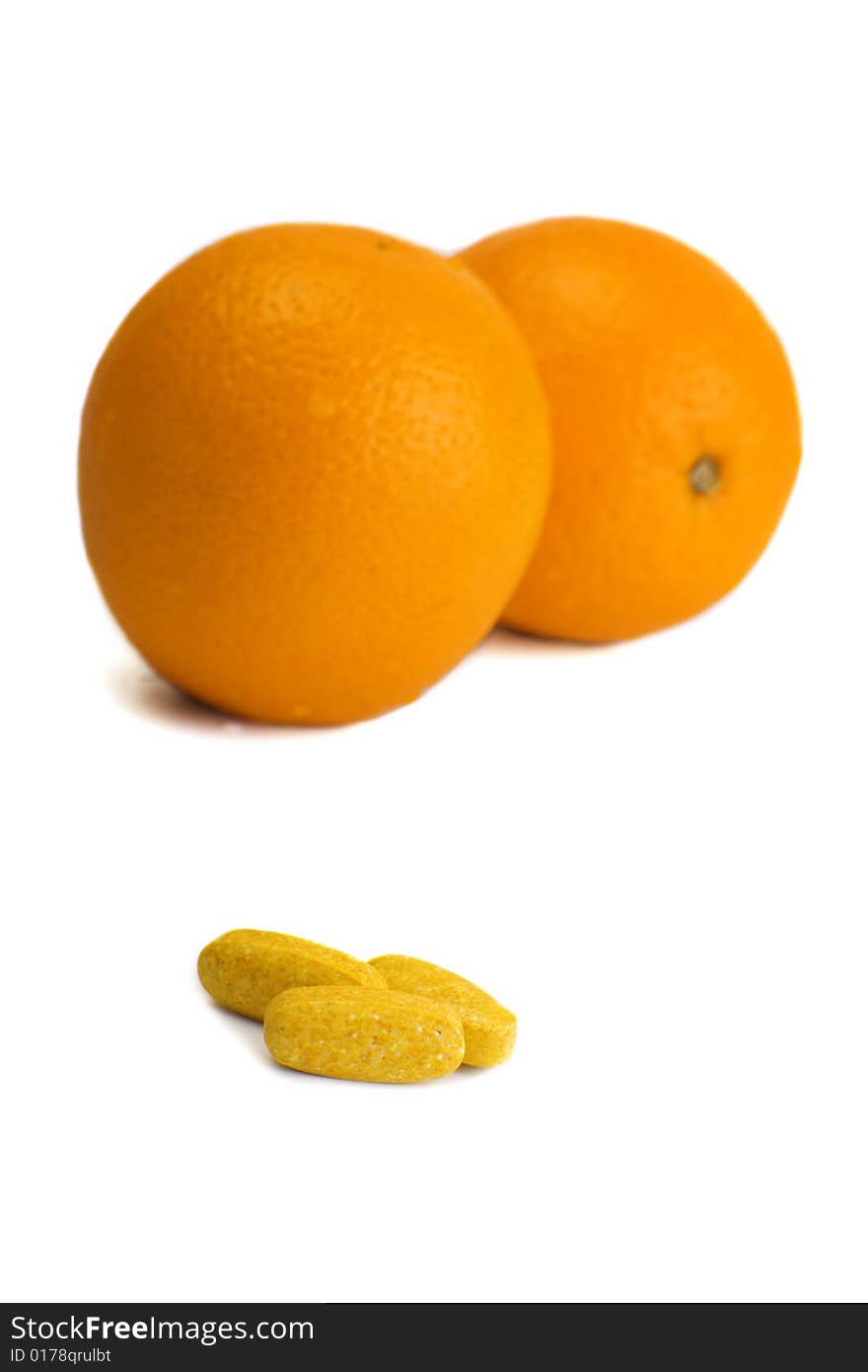 A photo of orange and pills. A photo of orange and pills