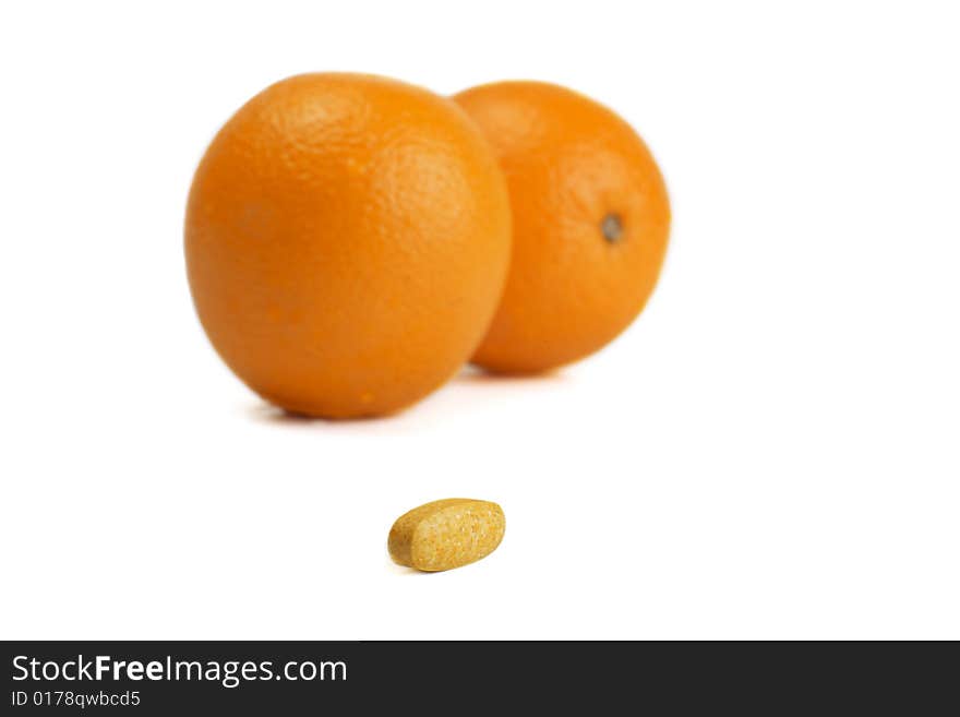 A photo of orange and pills. A photo of orange and pills