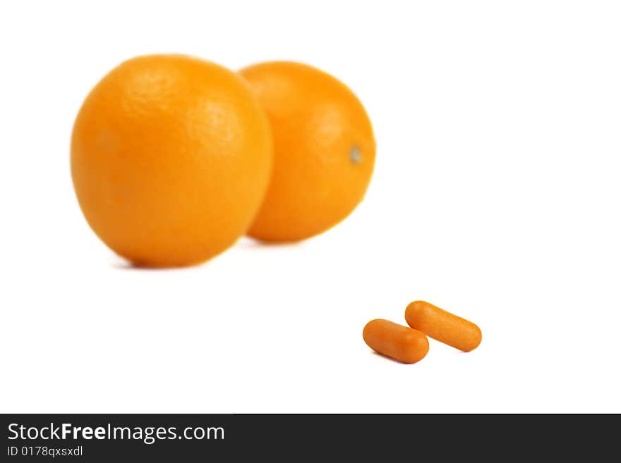 A photo of orange and pills. A photo of orange and pills