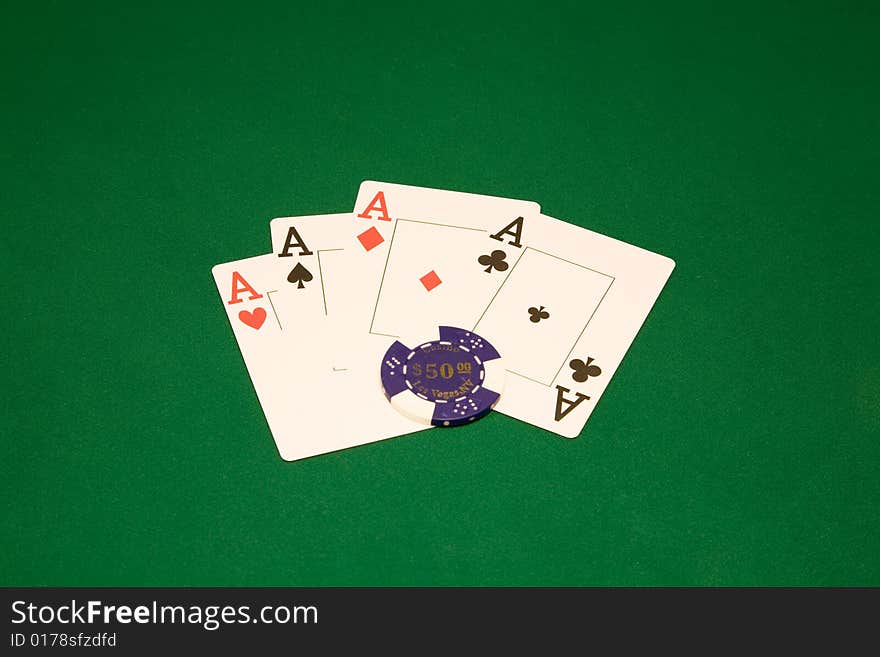 Four aces on the green table in casino with chips. Four aces on the green table in casino with chips