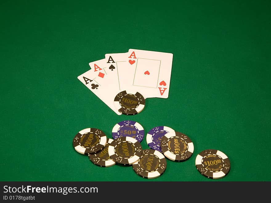 Chips with four aces on the green table in casino. Chips with four aces on the green table in casino