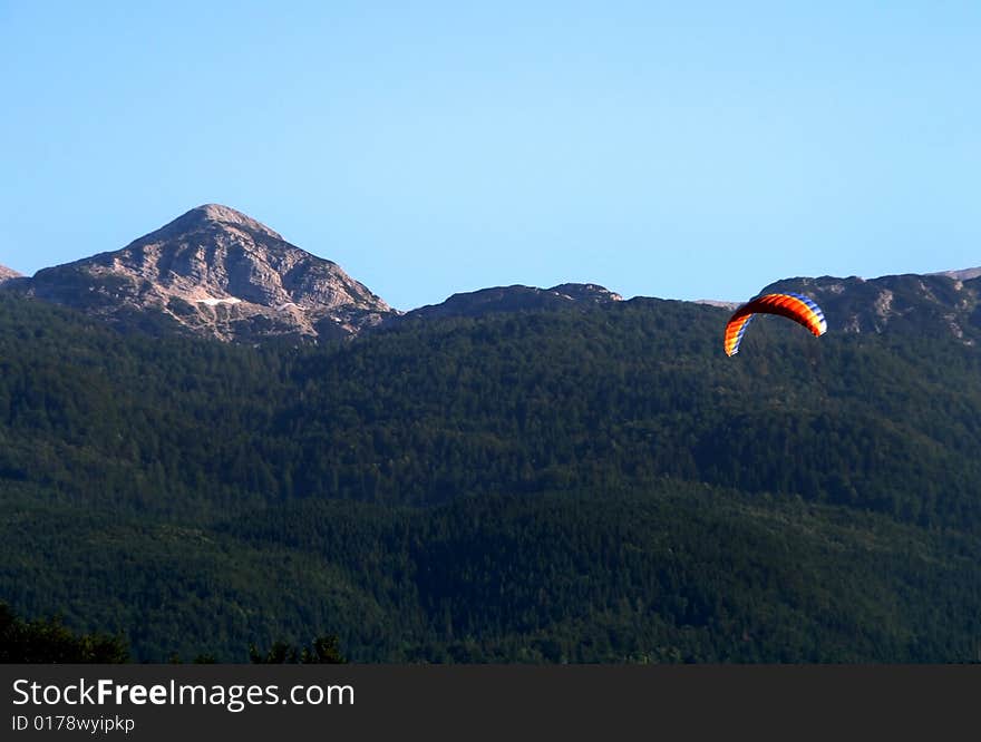 Kite in the sky with mountain in background. Kite in the sky with mountain in background