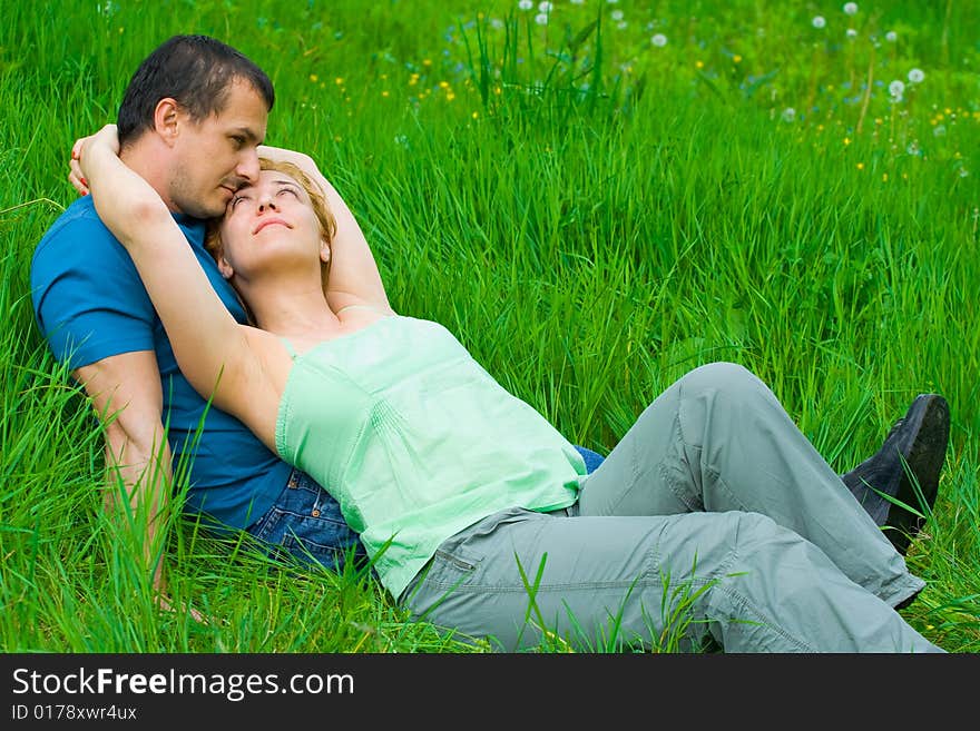 Young couple sitting in grass