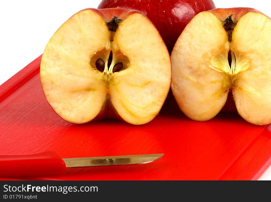 Red apple sitting on the edge of a wooden desk. Red apple sitting on the edge of a wooden desk