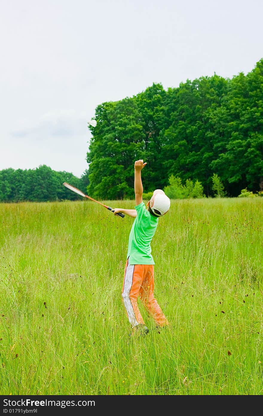 Cute kid playing badminton outdoors