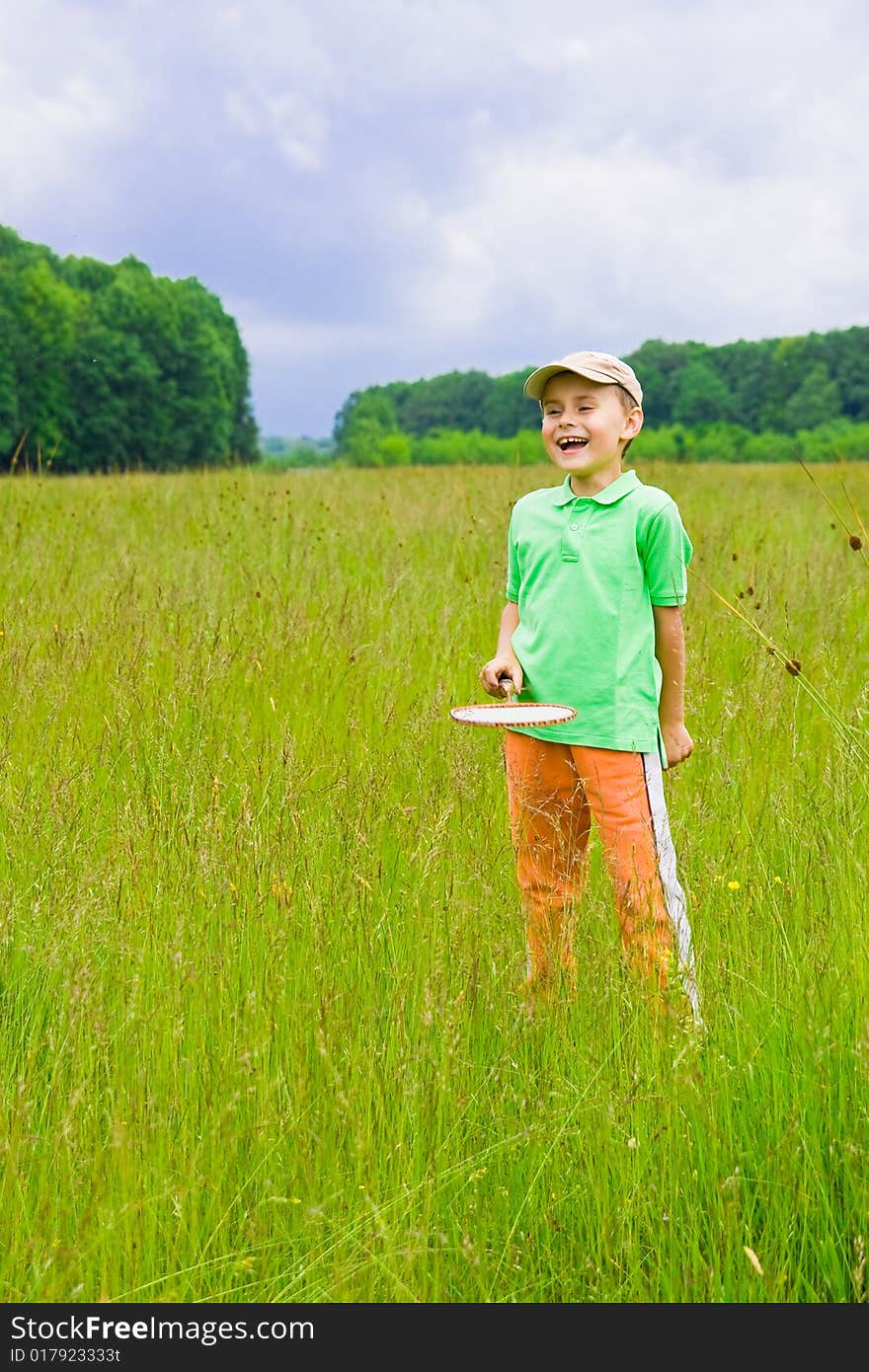 Cute kid playing badminton outdoors