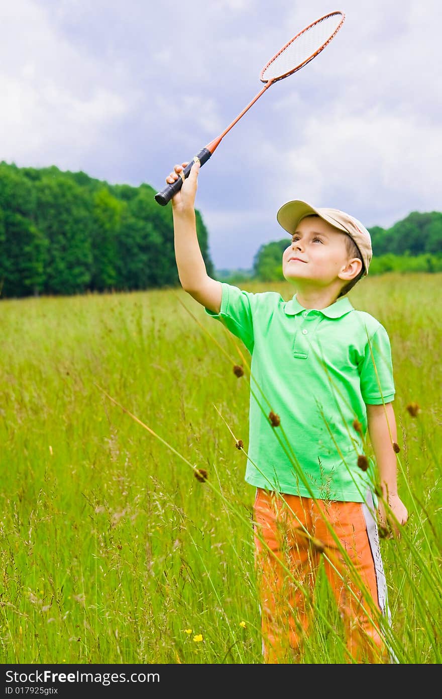 Cute kid playing badminton outdoors