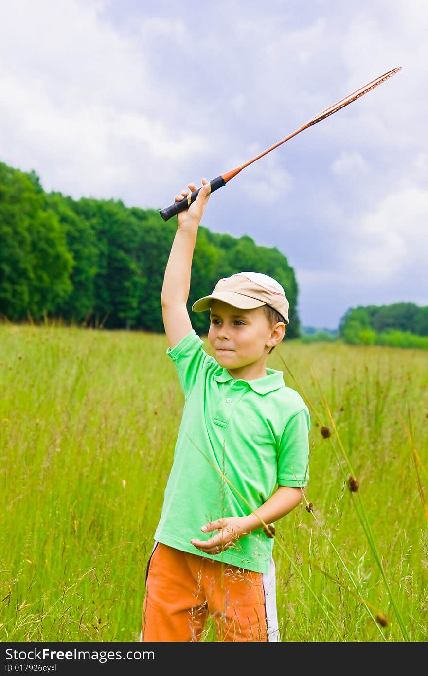 Cute kid playing badminton outdoors