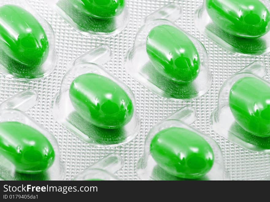 Green oval medical pills in their packages. Green oval medical pills in their packages