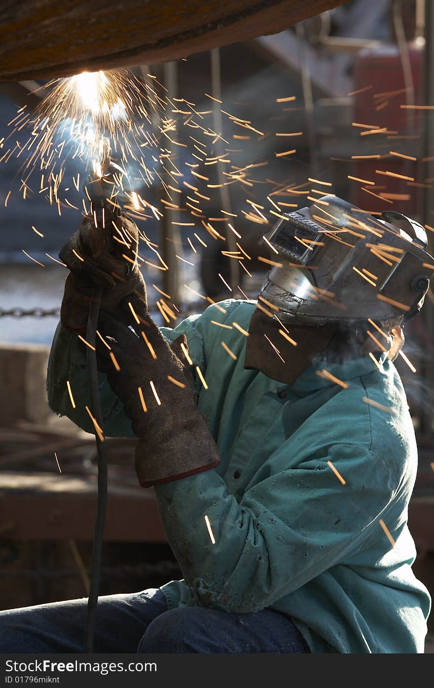 A welder working at shipyard on dayshift. A welder working at shipyard on dayshift