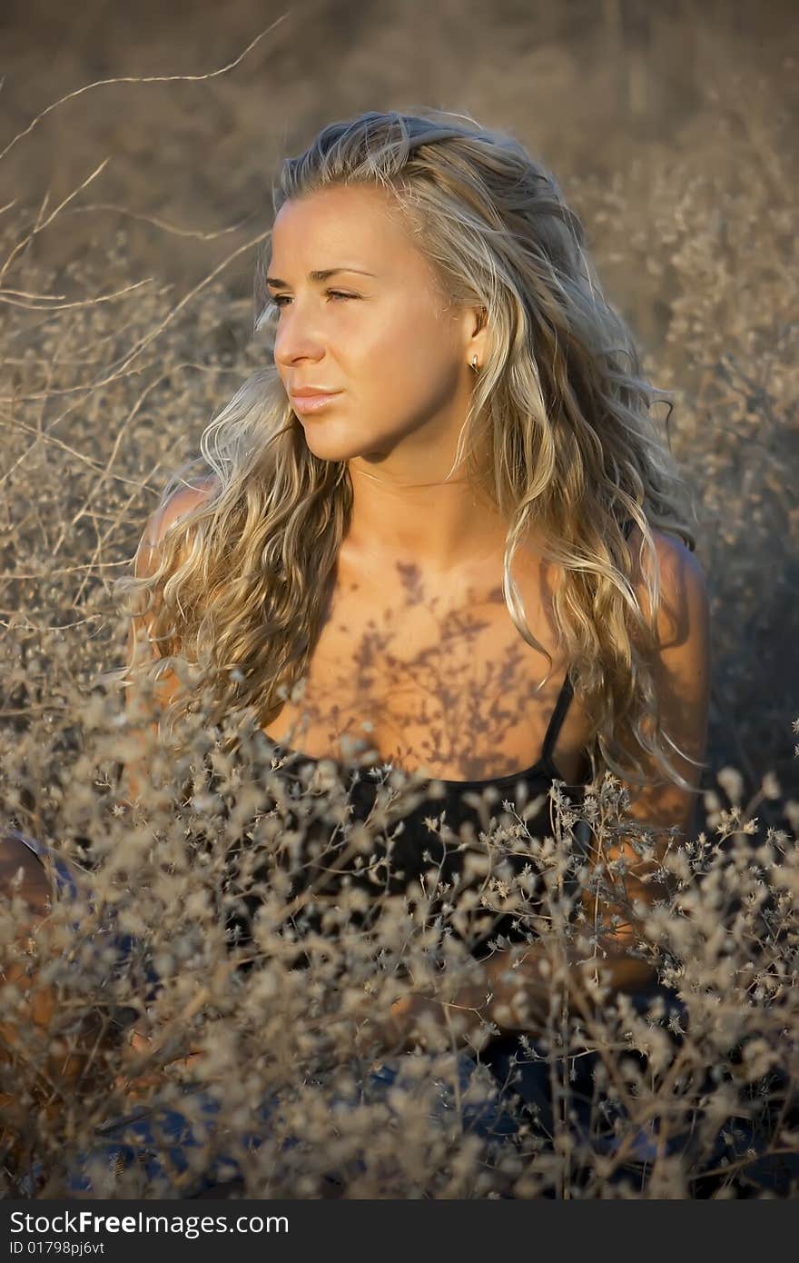 Girl sitting on straw grass in the valley. Girl sitting on straw grass in the valley