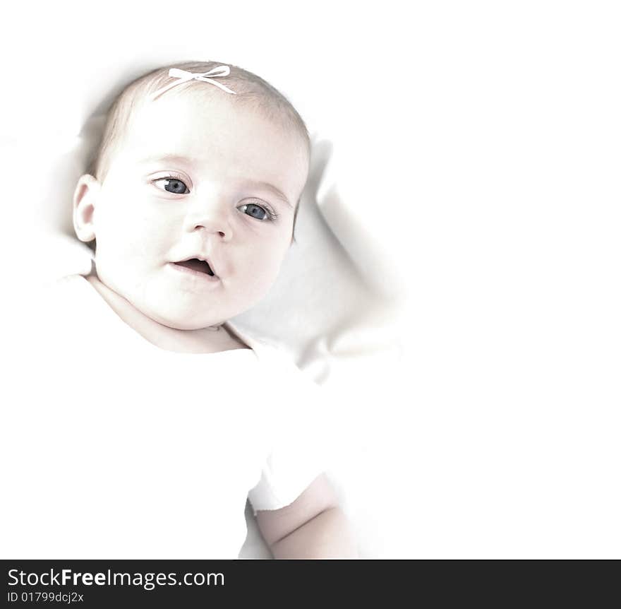 New born baby girl with bow lying on a white blanket. New born baby girl with bow lying on a white blanket