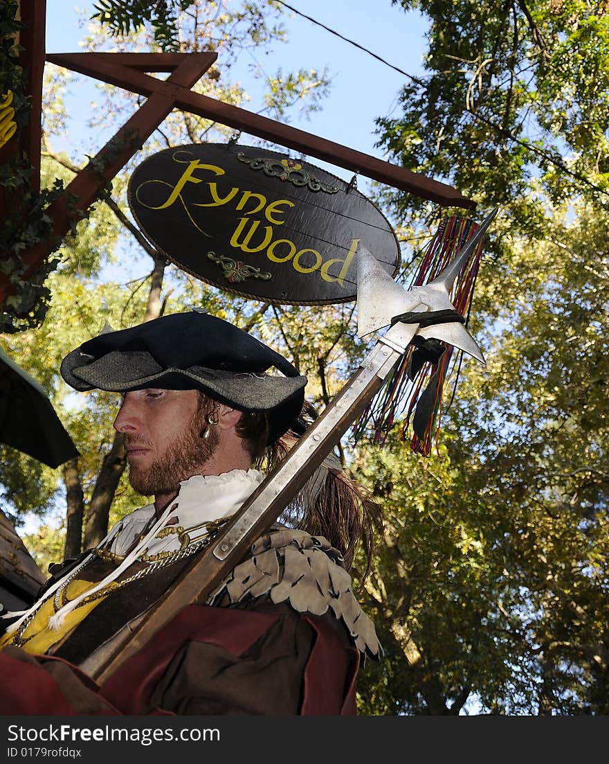 Renaissance Man Dressed up in full Wardrobe at Festival near Fyne Wood Vendor. Renaissance Man Dressed up in full Wardrobe at Festival near Fyne Wood Vendor