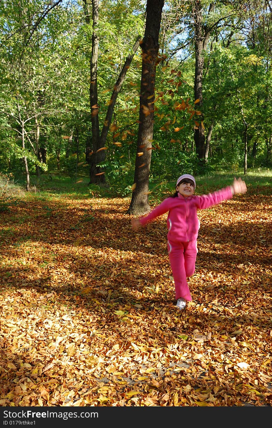 Funny happy child in autumn park