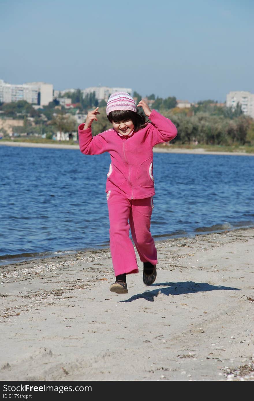 Running child on river shore