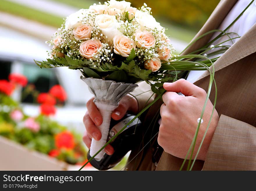 Bridegroom is holding flowers in his hand. Bridegroom is holding flowers in his hand