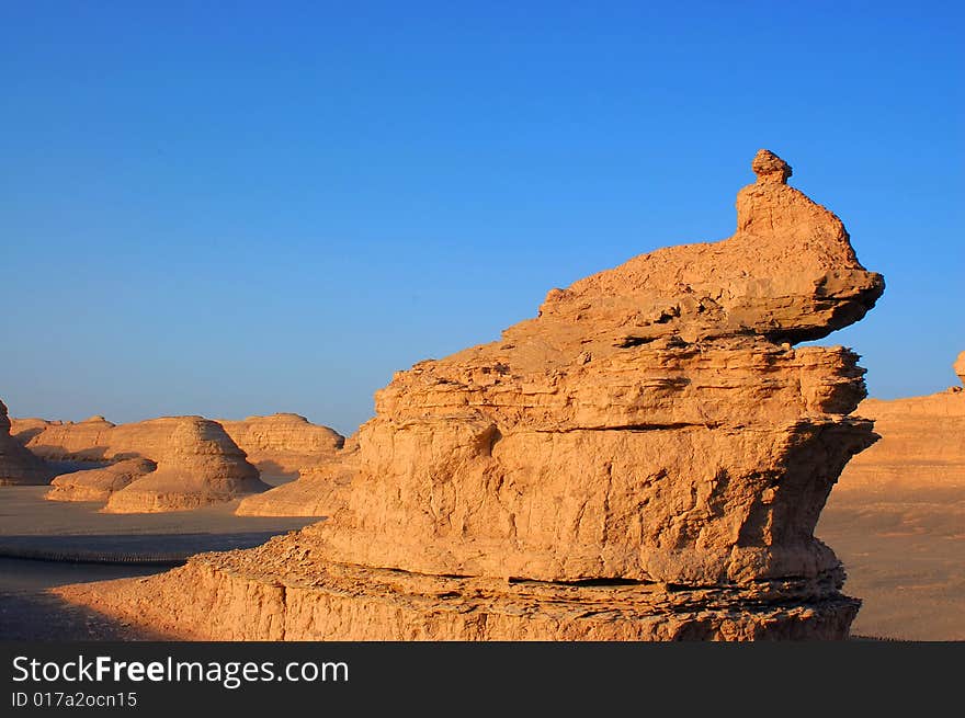 Yardang landform in northwest China A yardang is formed in cohesive material. Yardangs can be found in most deserts across the globe. Depending upon the winds and the composition of the weakly indurated deposits of silt and sand from which they are carved, yardangs may form very unusual shapes — some resemble various objects or even people.