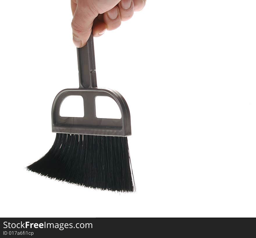 Brush in man hand. The tool for cleaning it is isolated on a white background