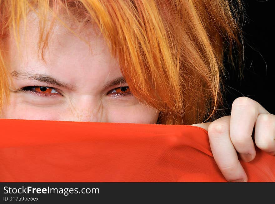 Portrait of Beautiful red girl with red eyes on black background