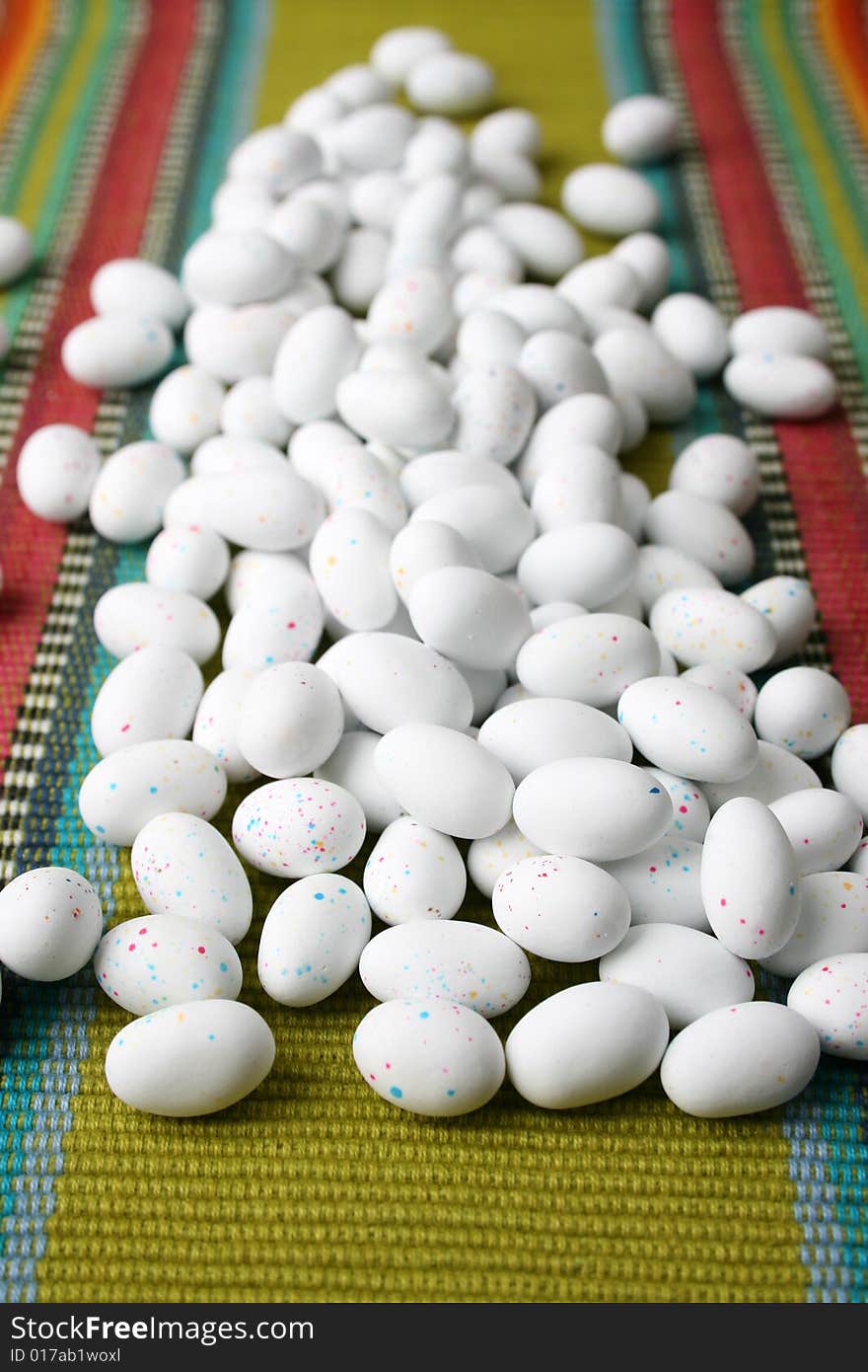 Miniature speckled easter eggs on a green place-mat. Miniature speckled easter eggs on a green place-mat