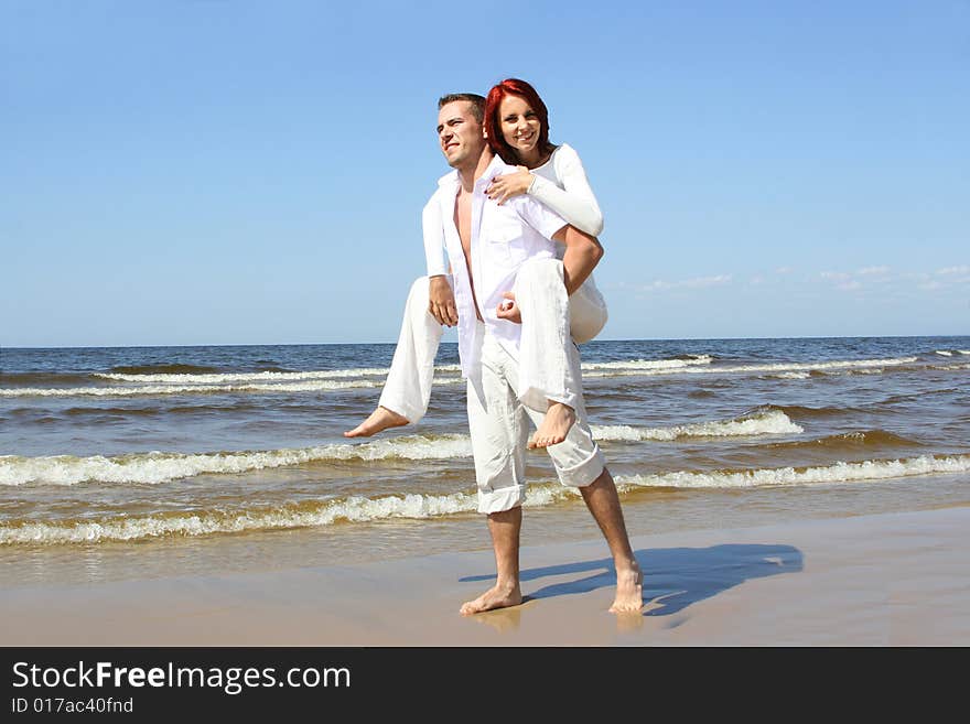 Beautiful yound couple relaxing on the beach. Beautiful yound couple relaxing on the beach