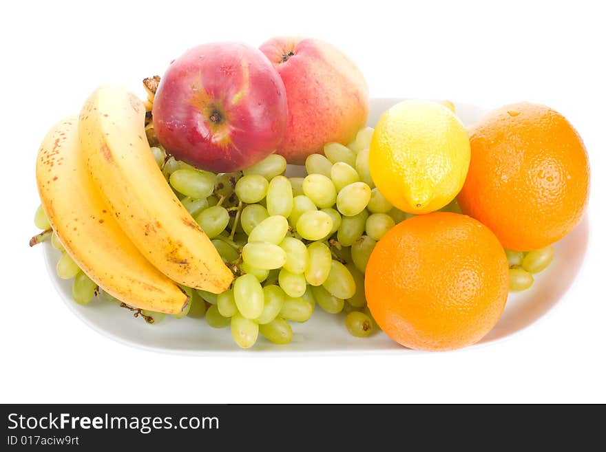 Close-up fruits on plate, isolated on white