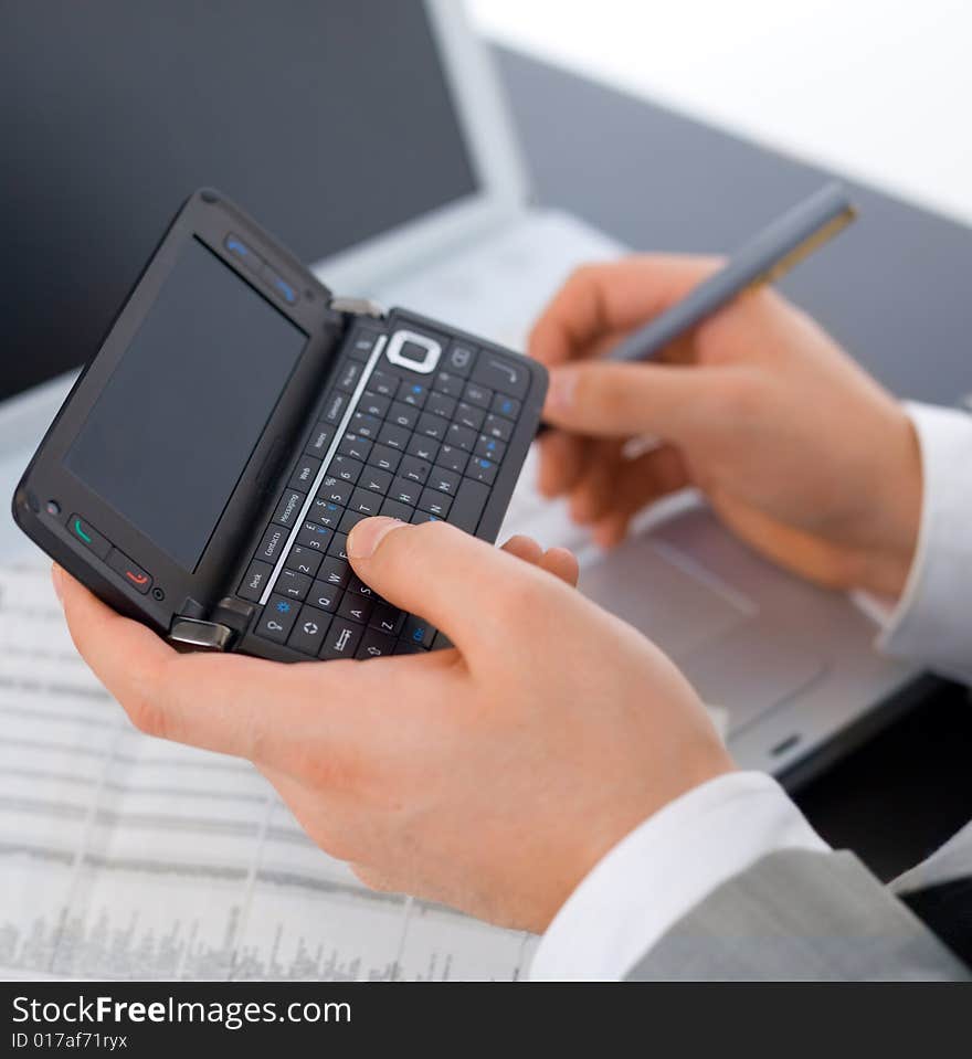 Close up of middle aged business man is working at the desk. Close up of middle aged business man is working at the desk