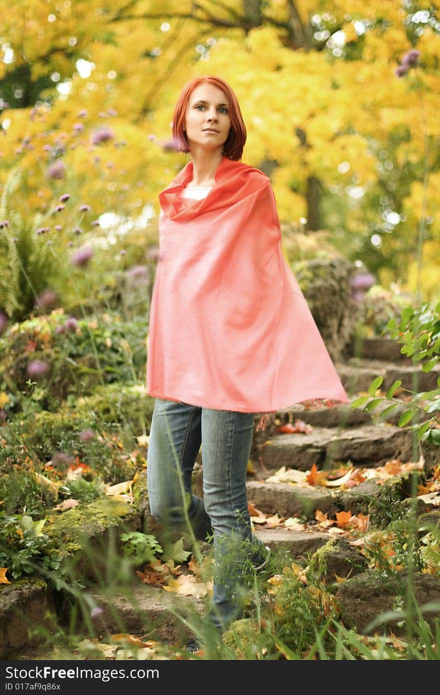 Young girl walking in autumn park. Young girl walking in autumn park