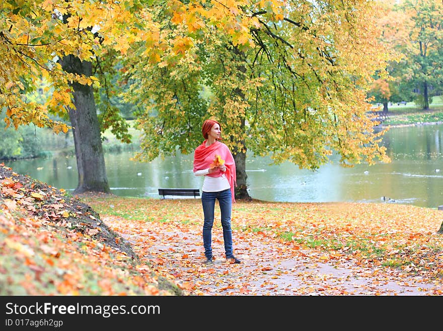 Young girl walking in autumn park. Young girl walking in autumn park