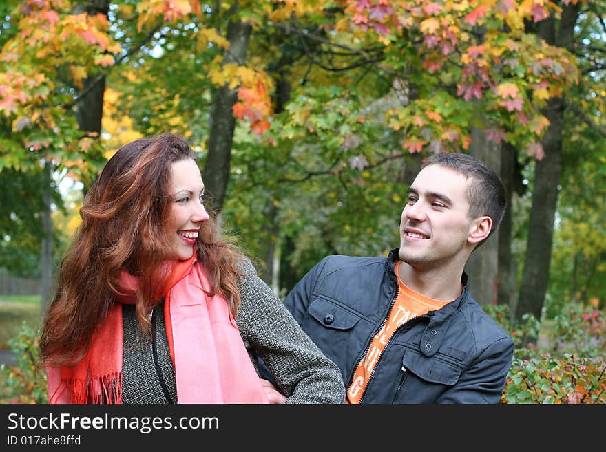 Funny couple having fun in autumn park