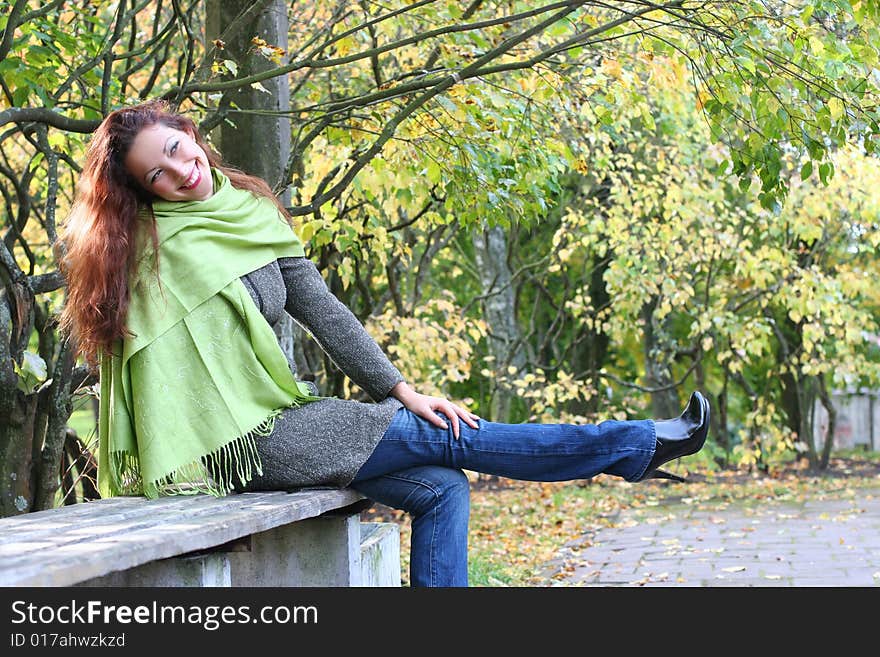 Young girl relaxing in autumn park. Young girl relaxing in autumn park