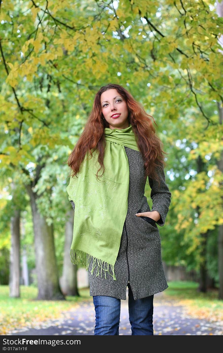 Young girl walking in autumn park. Young girl walking in autumn park