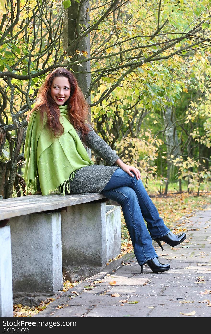 Young girl relaxing in autumn park. Young girl relaxing in autumn park