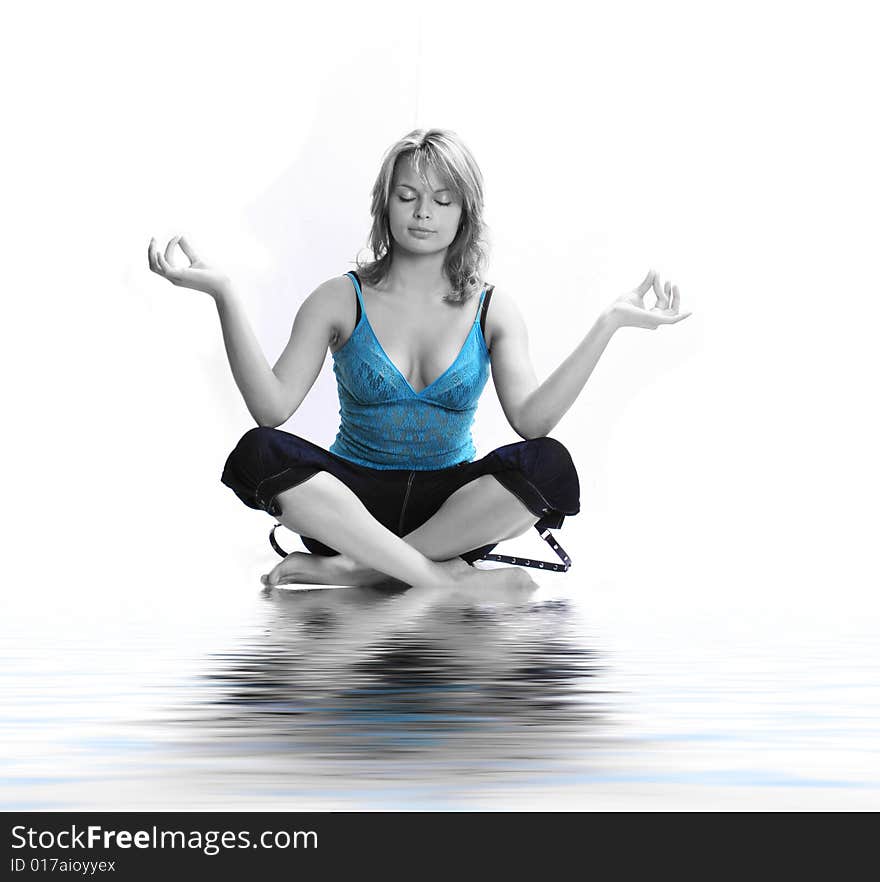 Young girl meditating in water. Young girl meditating in water