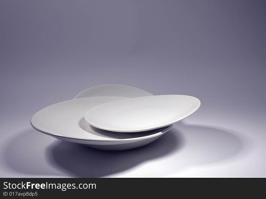 White plates and studio lighting shadows