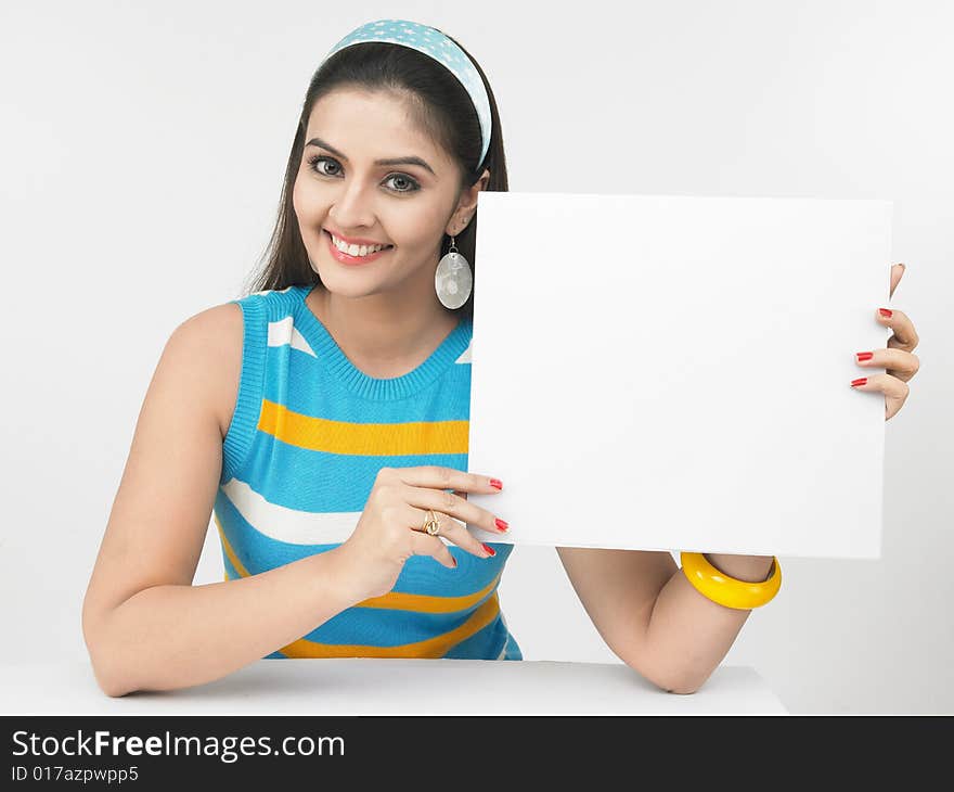 Asian woman of indian origin with a blank placard. Asian woman of indian origin with a blank placard