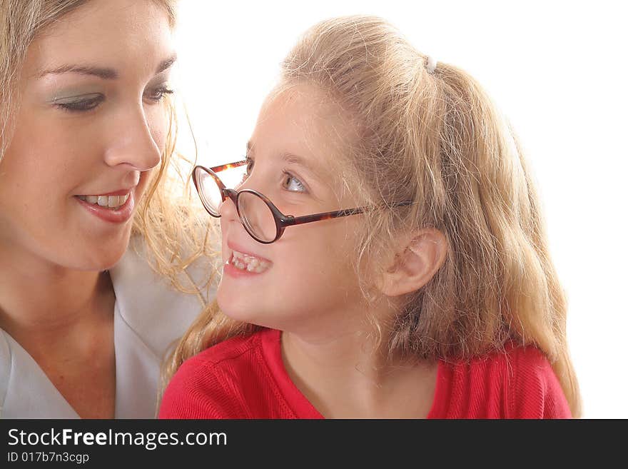 Little girl looking at mom with glasses smiling