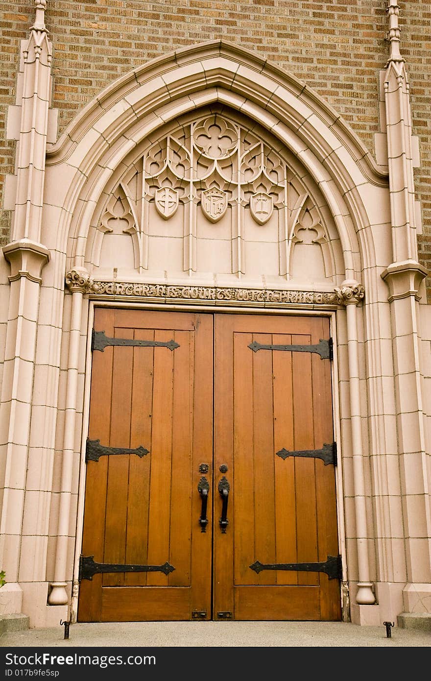 An old wooden church door with iron hinges and handles. An old wooden church door with iron hinges and handles