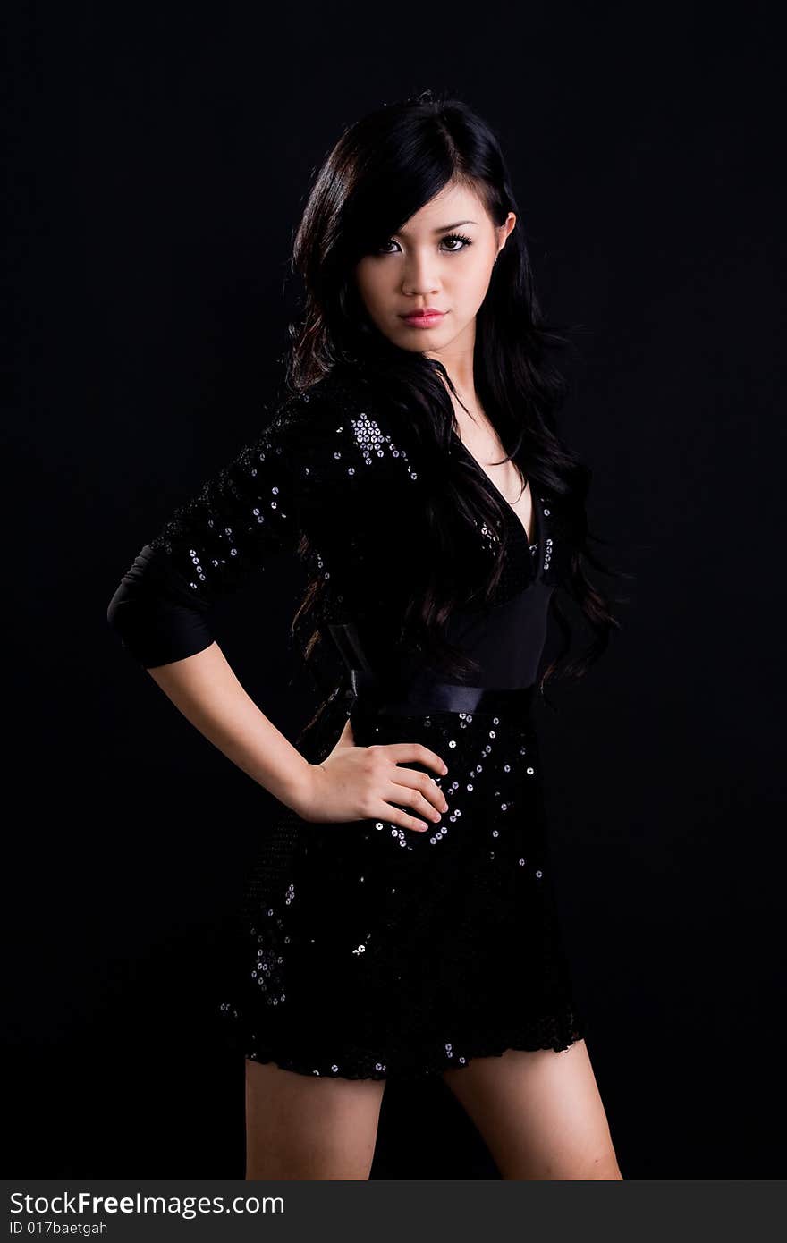 Beautiful asian girl in a glittering black cocktail dress. Beautiful asian girl in a glittering black cocktail dress