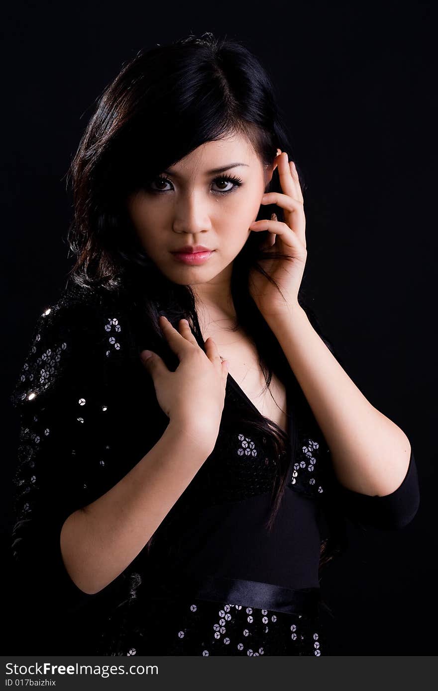 Beautiful asian girl in a glittering black cocktail dress. Beautiful asian girl in a glittering black cocktail dress