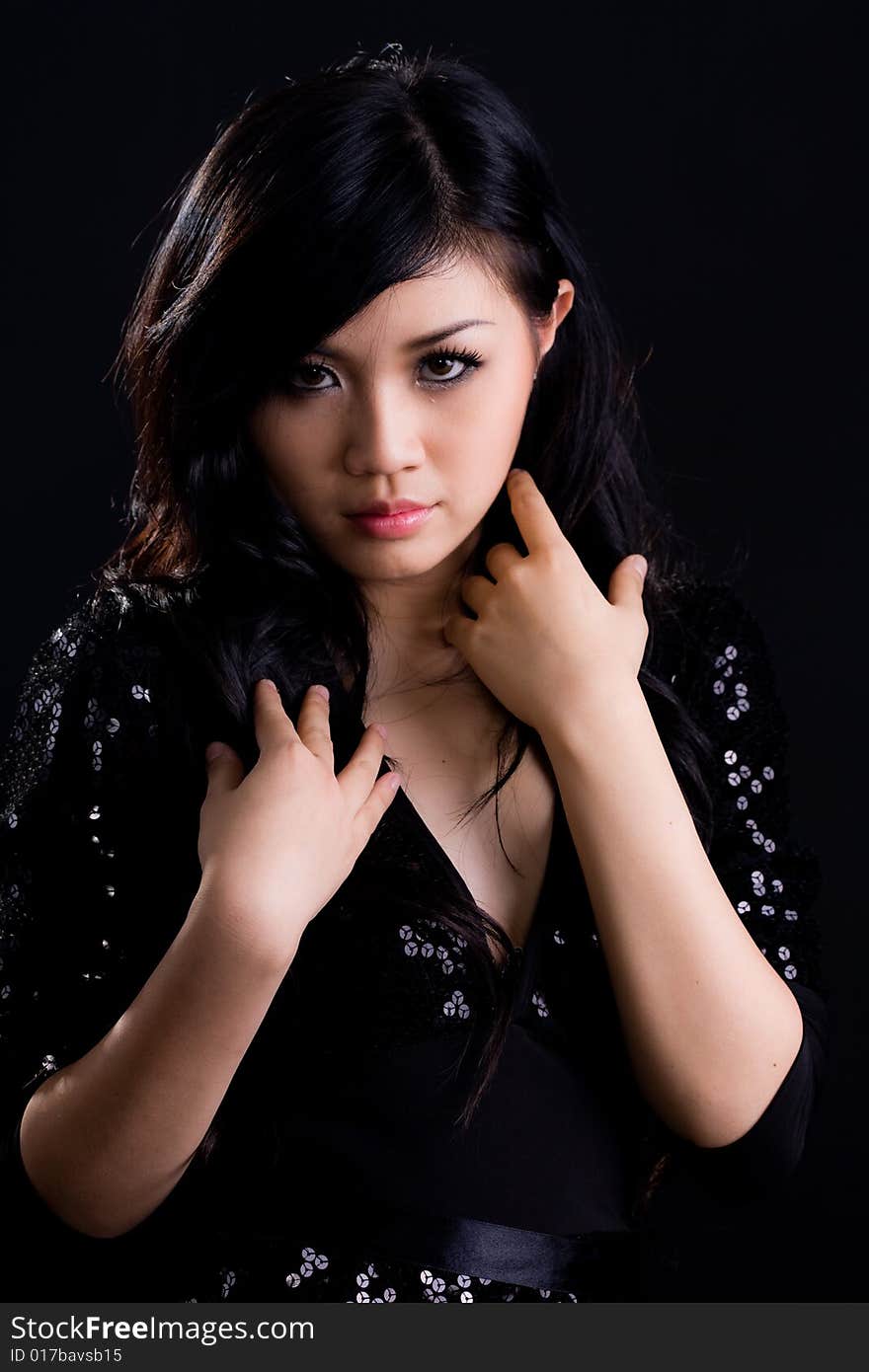 Beautiful asian girl in a glittering black cocktail dress. Beautiful asian girl in a glittering black cocktail dress