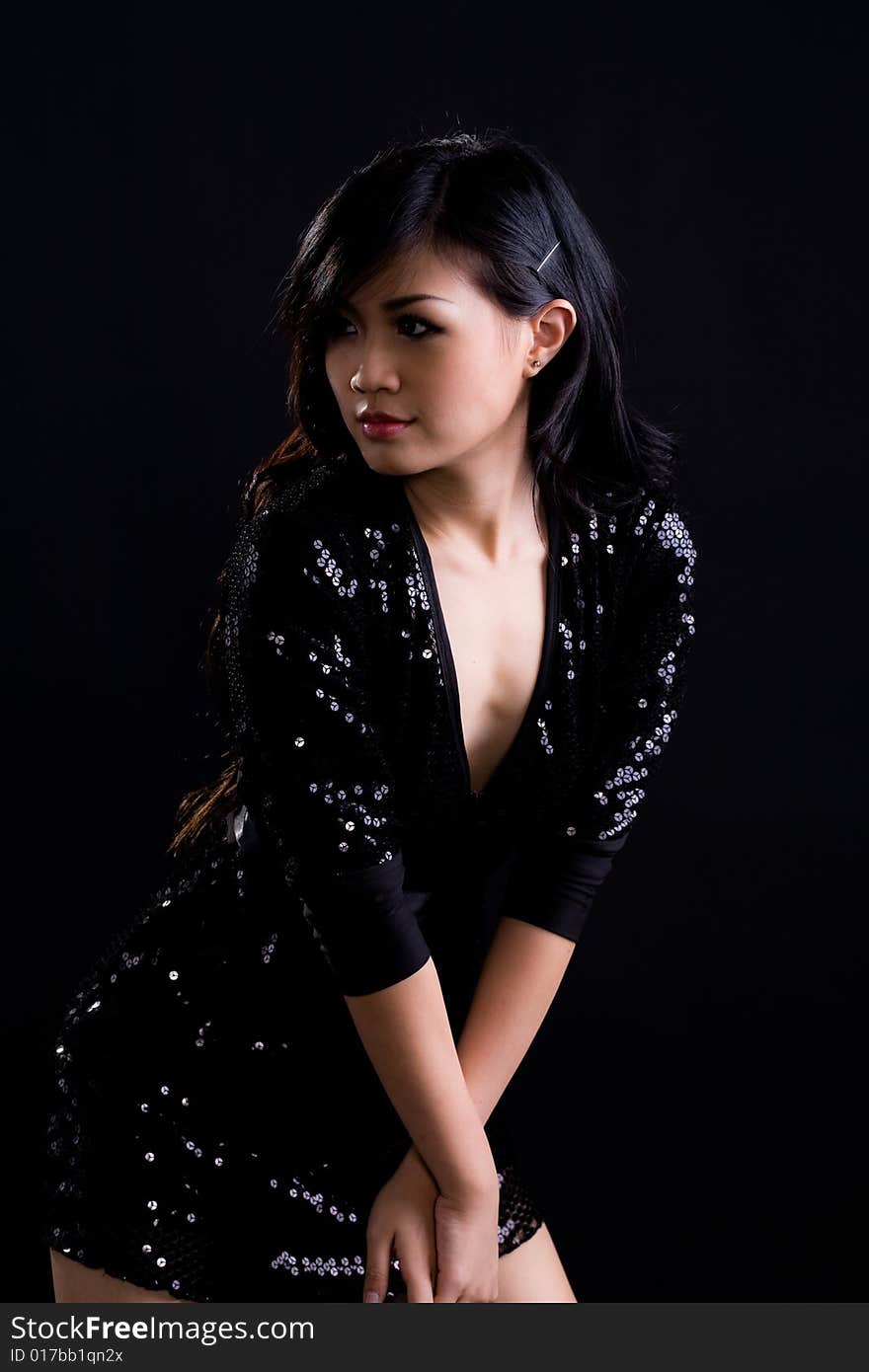 Beautiful asian girl in a glittering black cocktail dress. Beautiful asian girl in a glittering black cocktail dress