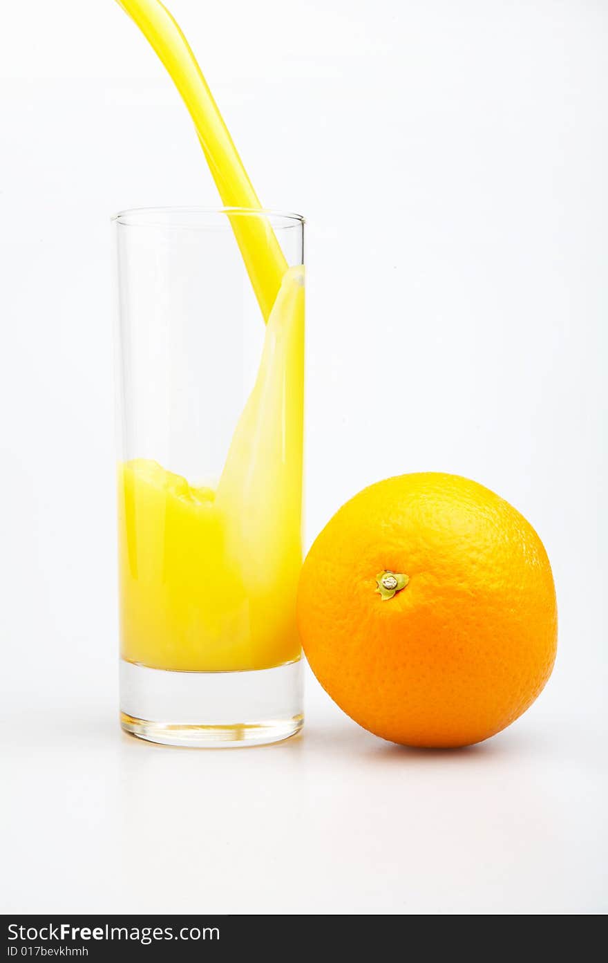 Glass of juice and orange on a white background. Glass of juice and orange on a white background