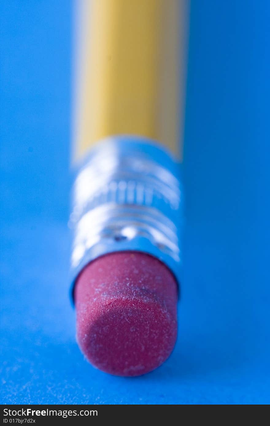Pencil erasers against blue background